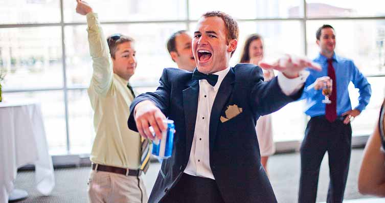 Guests dancing and celebrating at a wedding reception in Cincinnati, Kentucky, and Indiana with a DJ, photo booth, and event lighting.